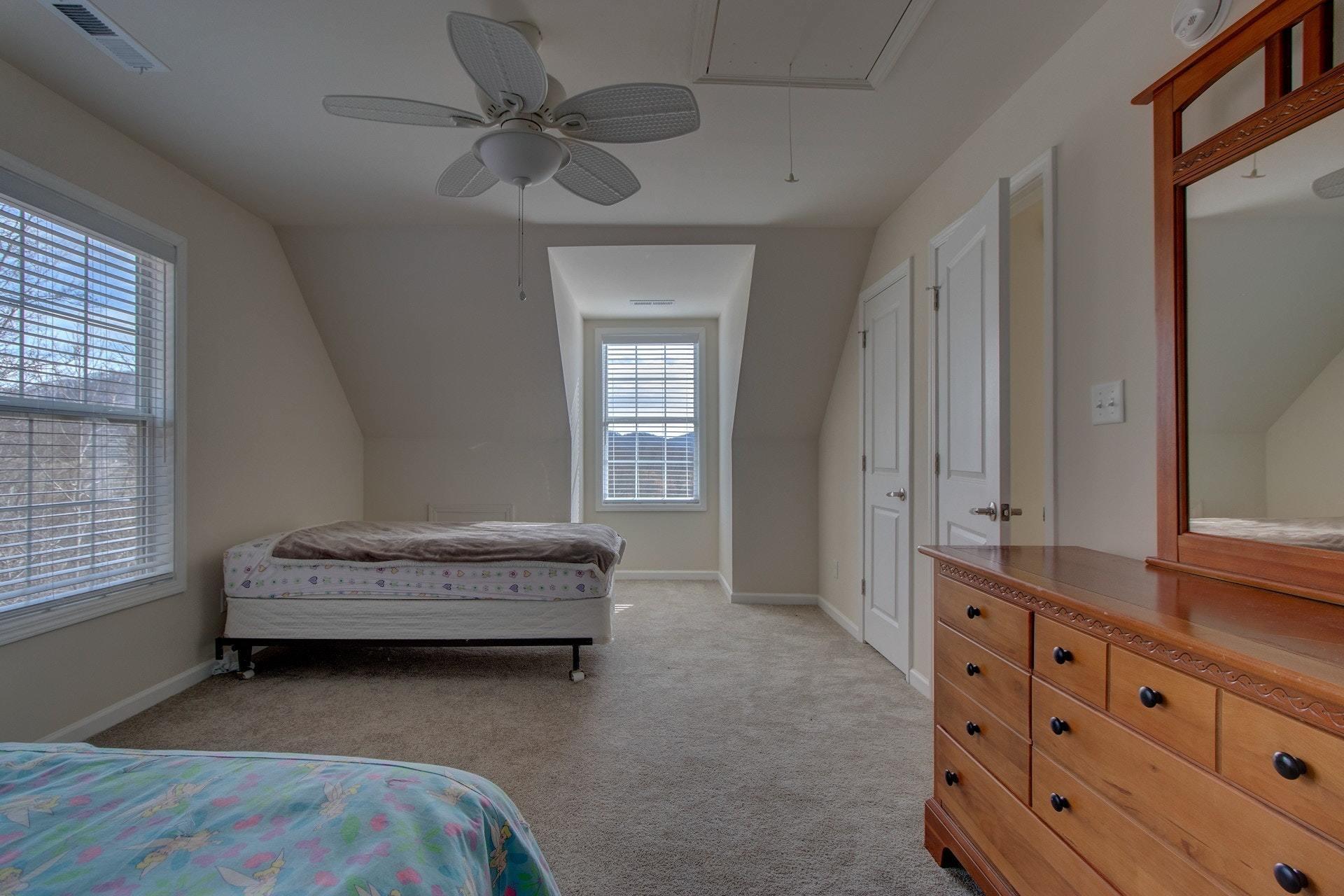 1381 Nemmo Road Vinton, VA 24179 - Photo 28 of 39 a spacious bedroom with a bed and a window