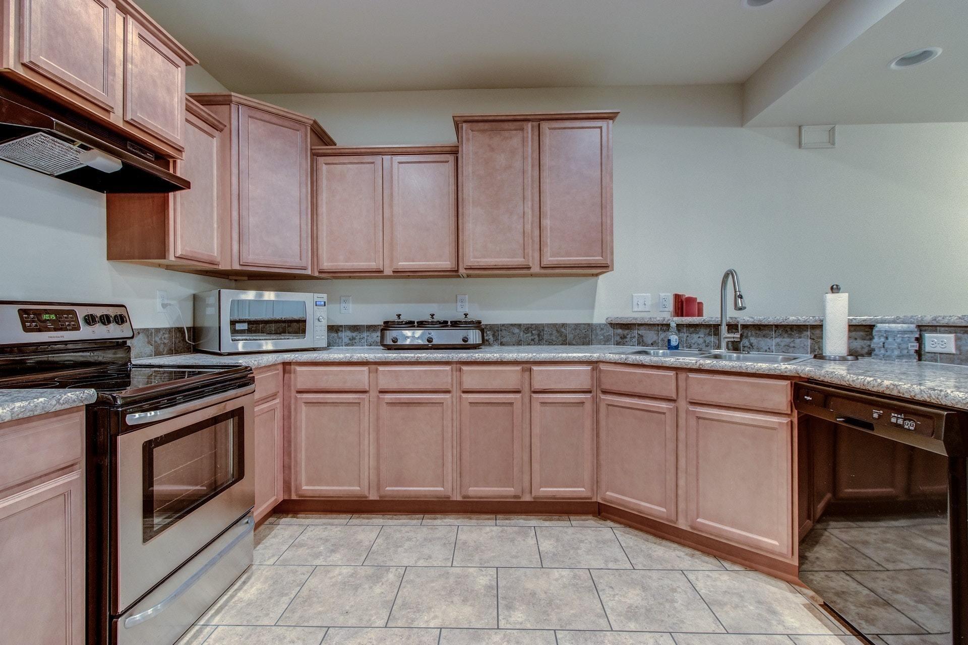 1381 Nemmo Road Vinton, VA 24179 - Photo 30 of 39 a kitchen with granite countertop a sink stove top oven and cabinets