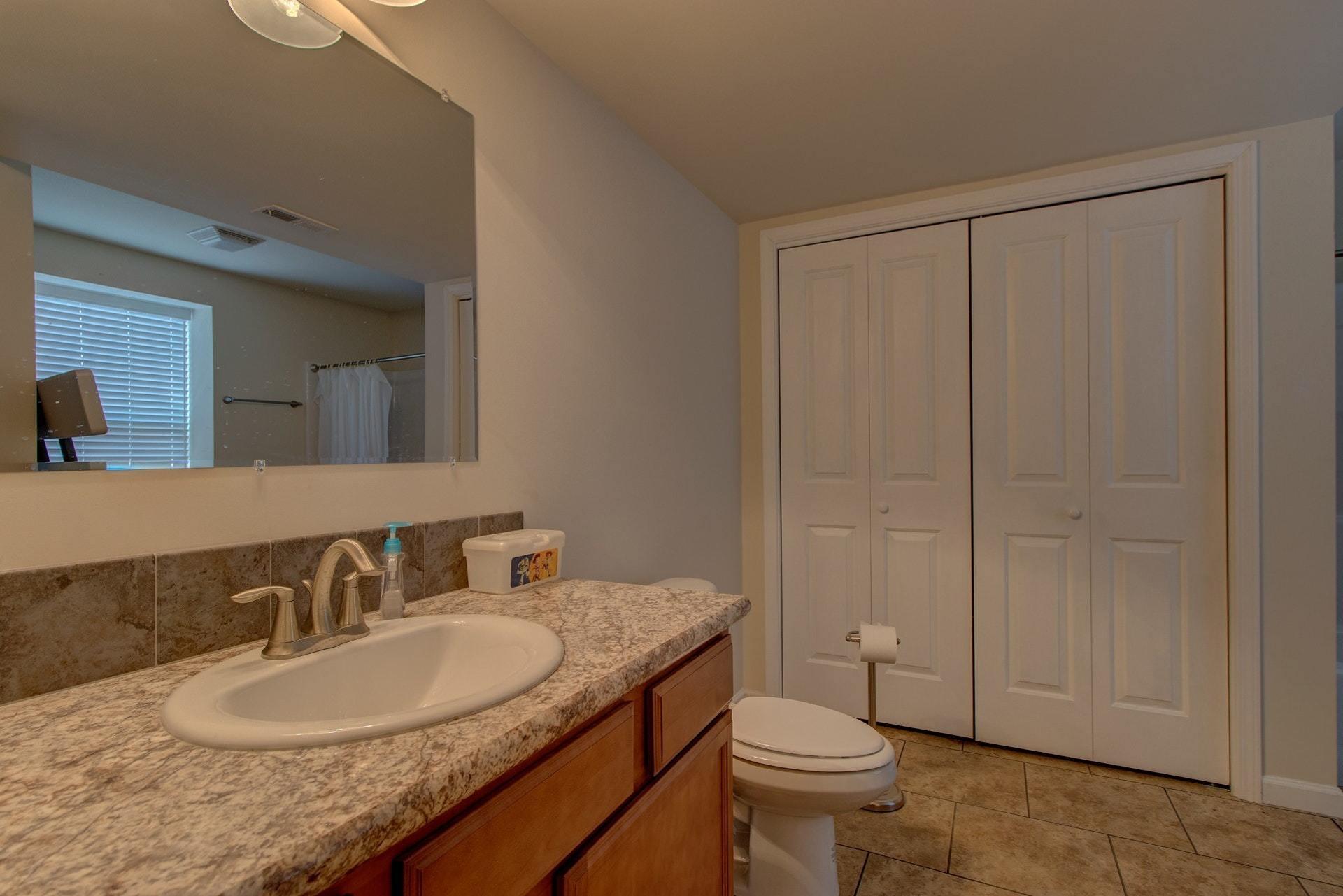 1381 Nemmo Road Vinton, VA 24179 - Photo 33 of 39 a bathroom with a granite countertop sink a toilet and a mirror