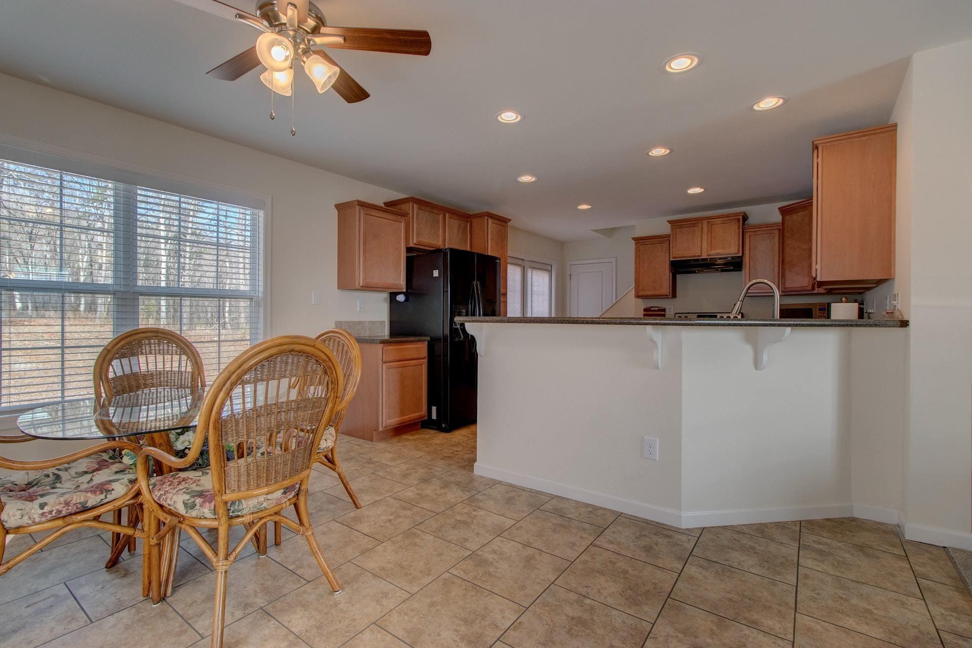 1381 Nemmo Road Vinton, VA 24179 - Photo 10 of 39 a kitchen with stainless steel appliances granite countertop a stove a sink a dining table and chairs