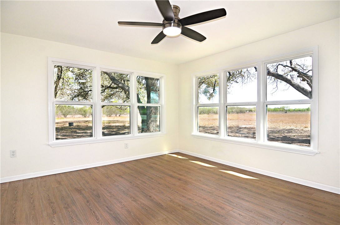 202 Ranch Road Mathis, TX 78368 - Photo 16 of 36 a view of an empty room with wooden floor and a window