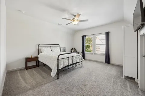 a bedroom with a bed and flat screen tv