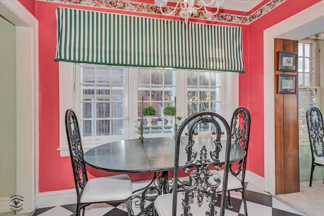 a view of a dining room with furniture and chandelier