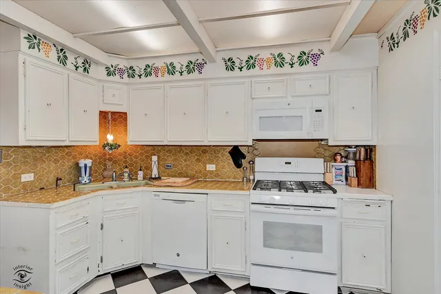 a kitchen with a stove a sink and a refrigerator