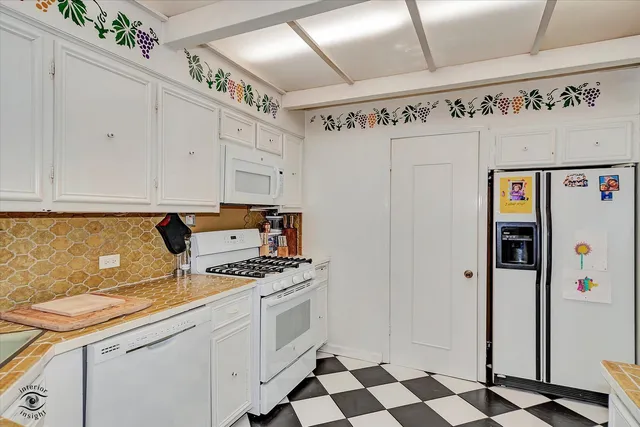 a kitchen with stainless steel appliances a stove a sink and a microwave