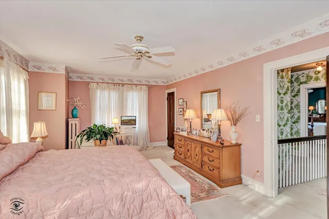 a bed room with a bed and a potted plant