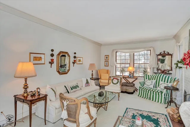 a living room with furniture a fireplace and a window