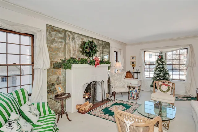 a dining room with furniture a chandelier and window