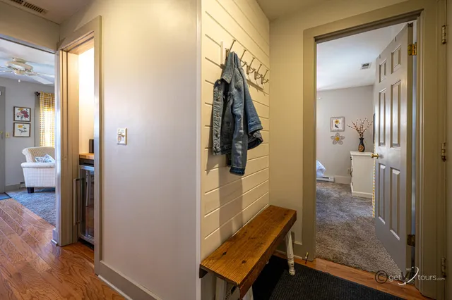 a view of a bathroom with mirror and door