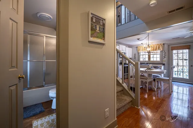 a view of entryway and hall with wooden floor