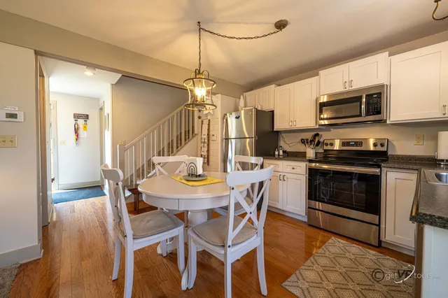 a kitchen that has a table and chairs in it