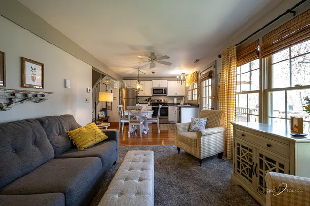 a living room with furniture and large windows