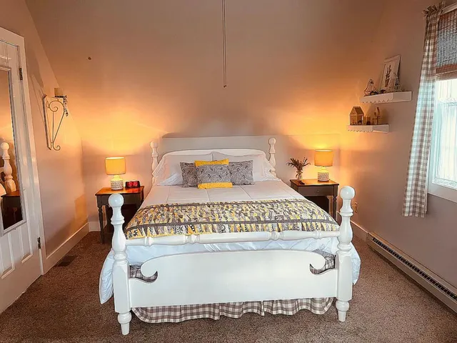 a bedroom with a bed and window