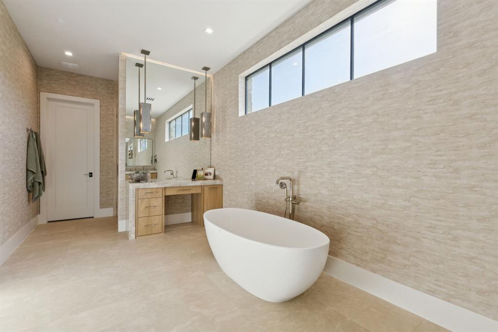 2600 Magnolia Circle Roanoke, TX 76262 - Photo 21 of 39 a bathroom with a white tub shower sink and mirror