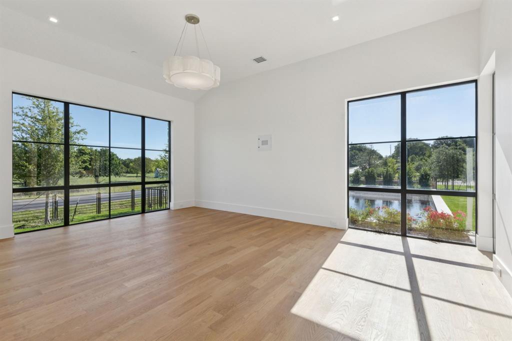 2600 Magnolia Circle Roanoke, TX 76262 - Photo 32 of 39 a view of an empty room with wooden floor and a floor to ceiling window