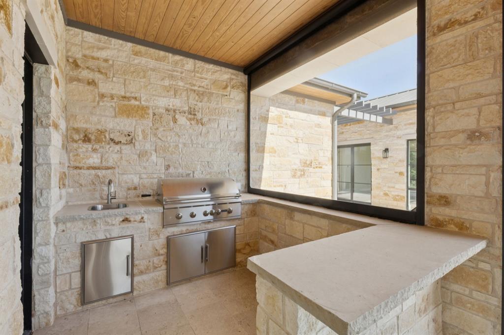 2600 Magnolia Circle Roanoke, TX 76262 - Photo 33 of 39 a kitchen that has a sink a stove and white cabinets with wooden floor