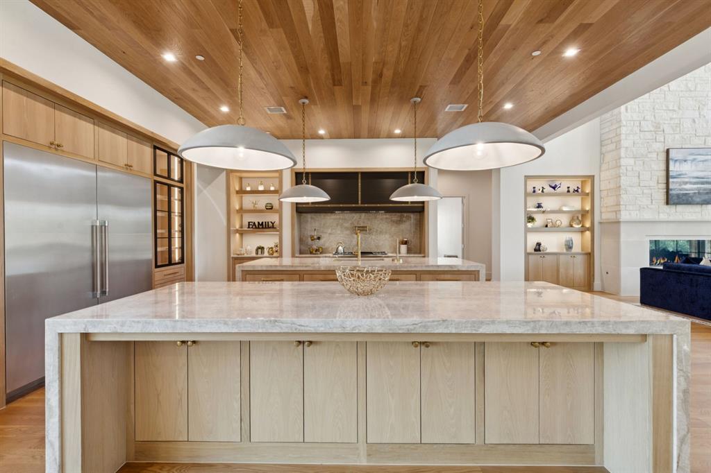 2600 Magnolia Circle Roanoke, TX 76262 - Photo 8 of 39 a kitchen with kitchen island a counter top a stove and a refrigerator