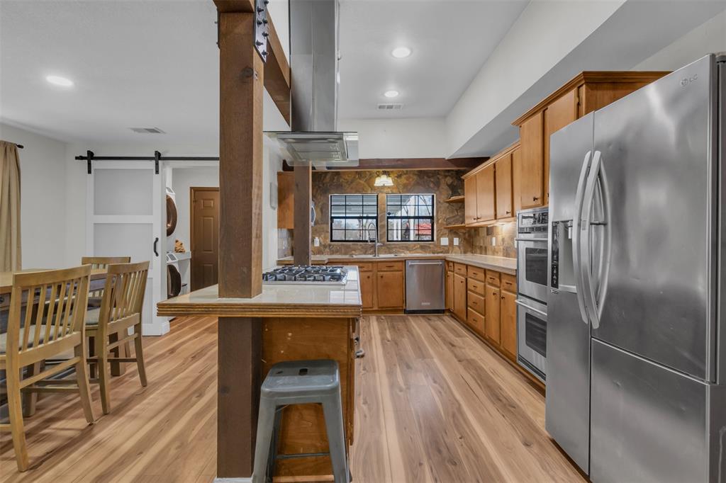 906 Griffith Avenue Terrell, TX 75160 - Photo 13 of 37 a kitchen with stainless steel appliances granite countertop a refrigerator a stove and a sink