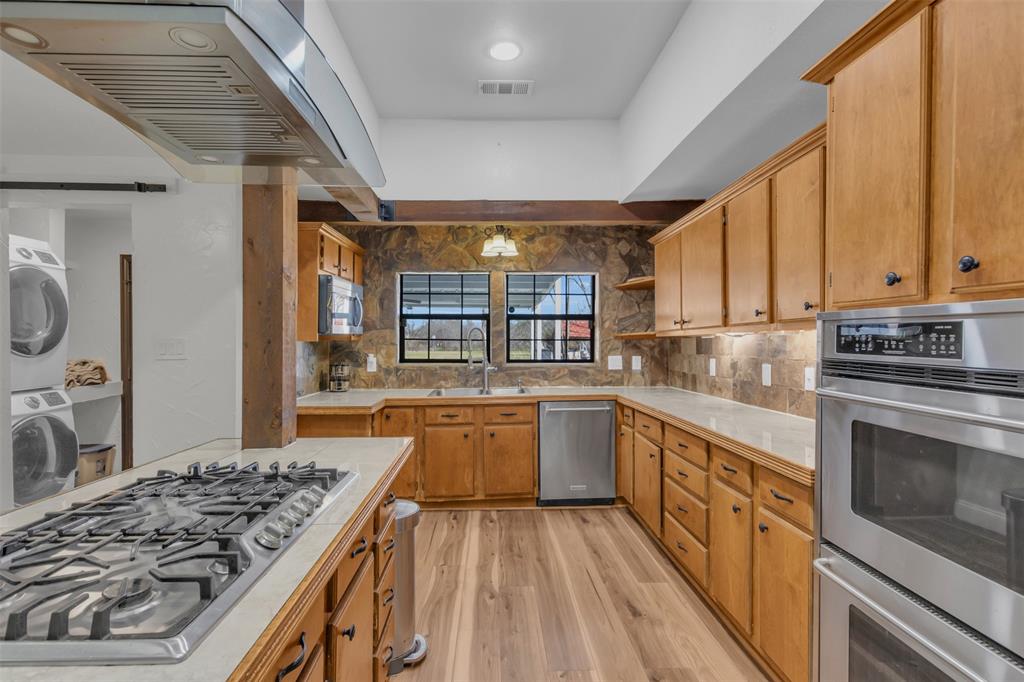 906 Griffith Avenue Terrell, TX 75160 - Photo 14 of 37 a kitchen with stainless steel appliances granite countertop a stove and a sink