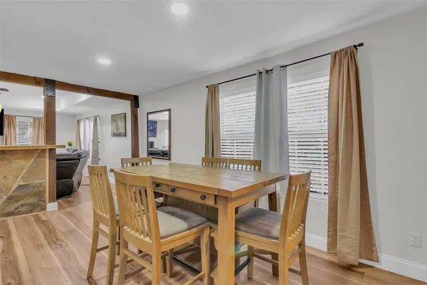 a dining room with furniture and window