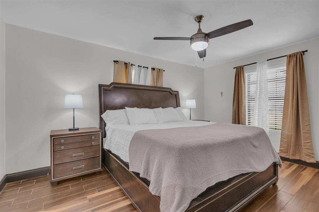 906 Griffith Avenue Terrell, TX 75160 - Photo 19 of 37 a bedroom with a bed and wooden floor