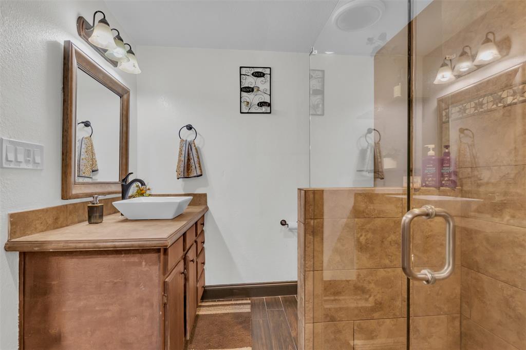 906 Griffith Avenue Terrell, TX 75160 - Photo 22 of 37 a bathroom with a granite countertop sink and a mirror