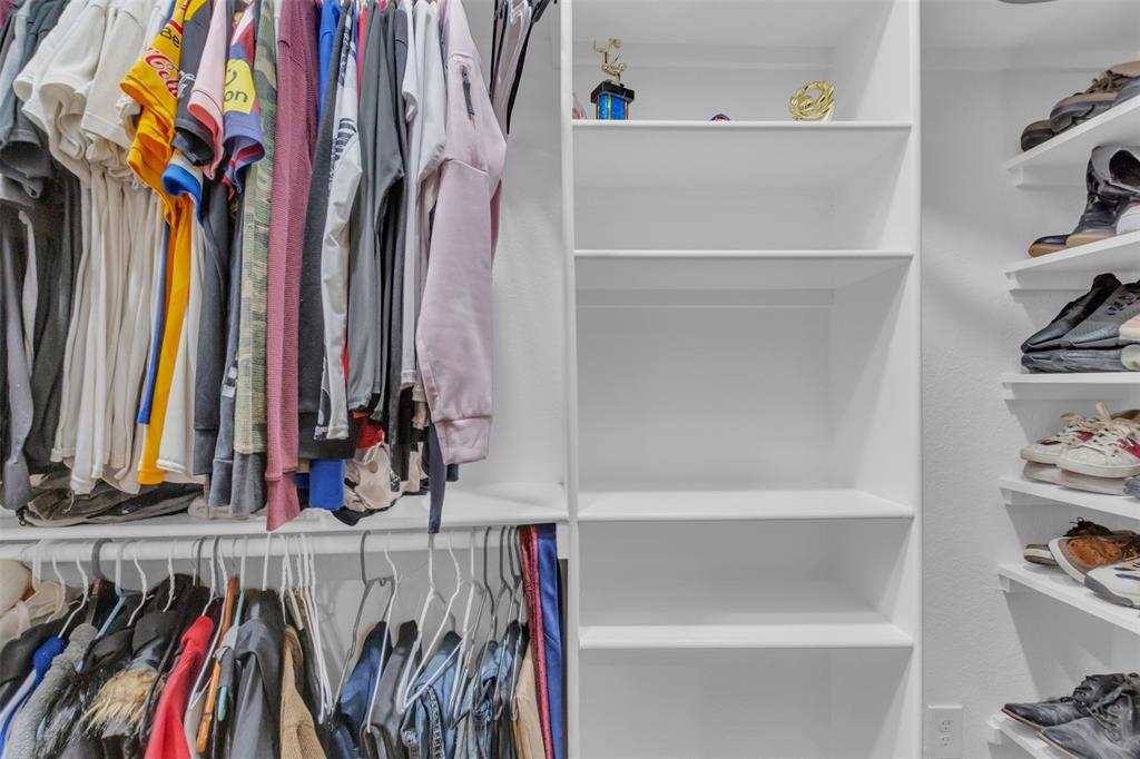 906 Griffith Avenue Terrell, TX 75160 - Photo 25 of 37 a view of walk in closet with clothes and shoes