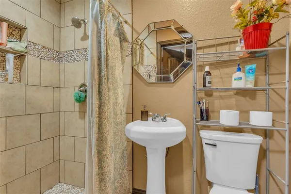 a bathroom with a sink a mirror and a shower