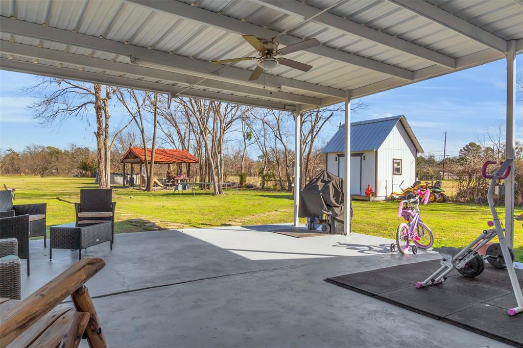 906 Griffith Avenue Terrell, TX 75160 - Photo 30 of 37 a view of swimming pool with lounge chair and dinning table under an umbrella