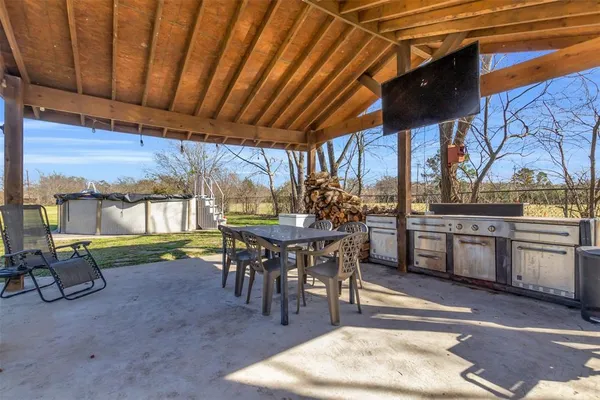 a patio with a table and chairs