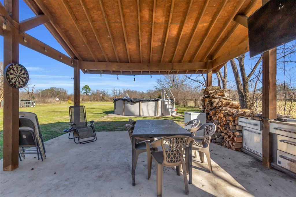 906 Griffith Avenue Terrell, TX 75160 - Photo 33 of 37 a view of a patio with a table chairs and a backyard