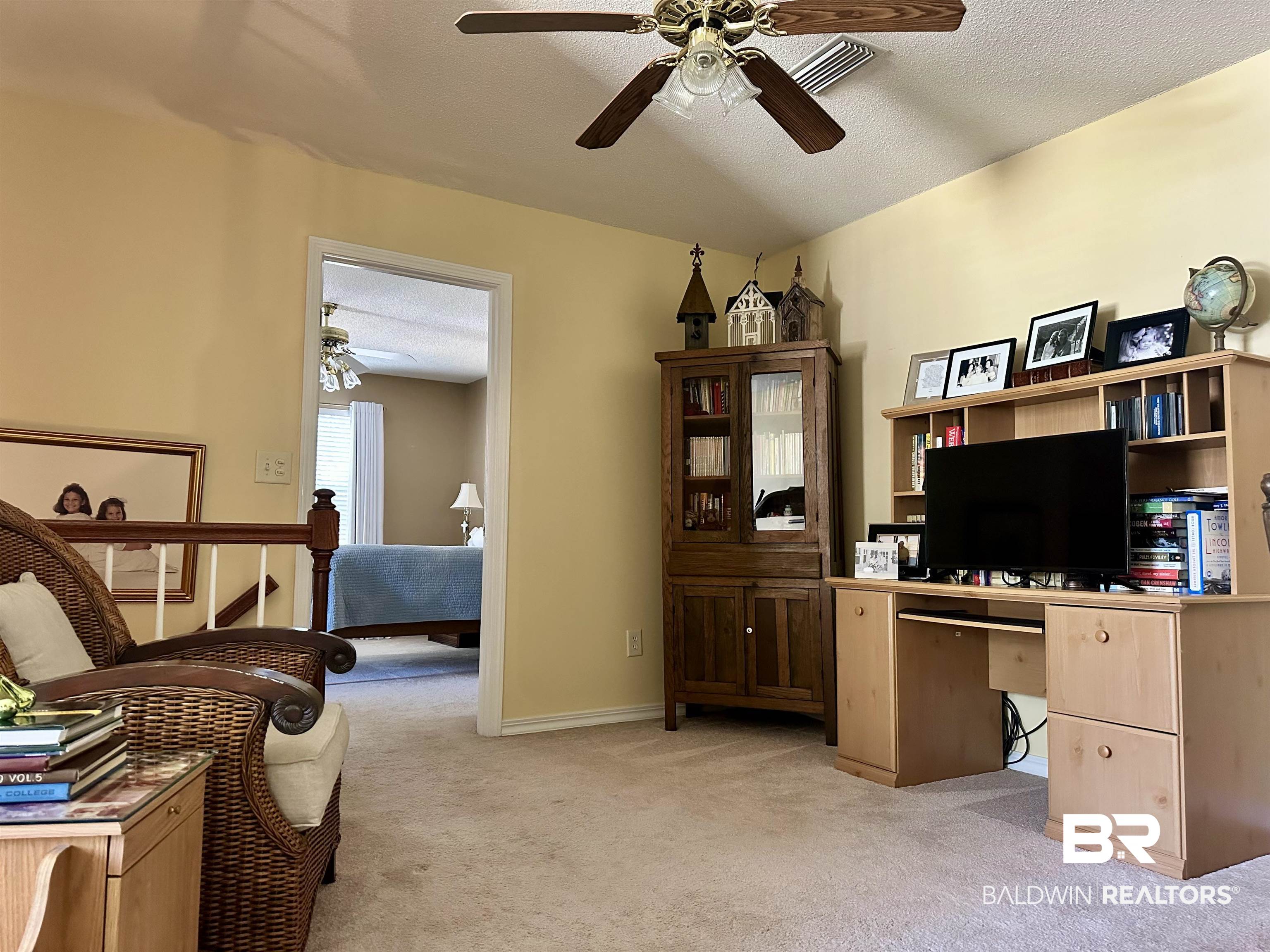148 Brooks Boulevard Brewton, AL 36426 - Photo 32 of 45 Home office with light carpet, baseboards, a textured ceiling, and a ceiling fan