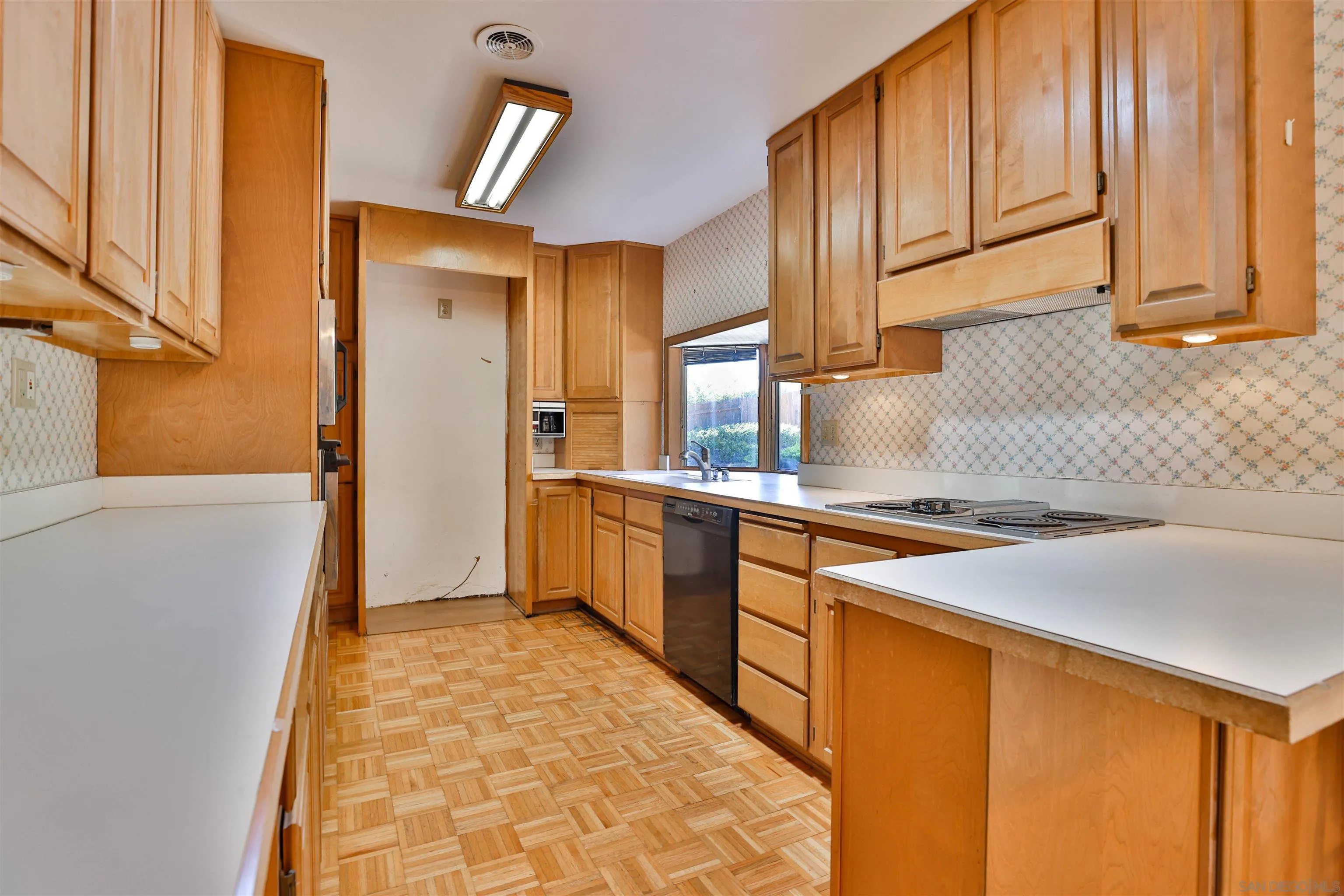 10320 Rancho Road La Mesa, CA 91941 - Photo 14 of 43 a kitchen with stainless steel appliances granite countertop a sink and a refrigerator