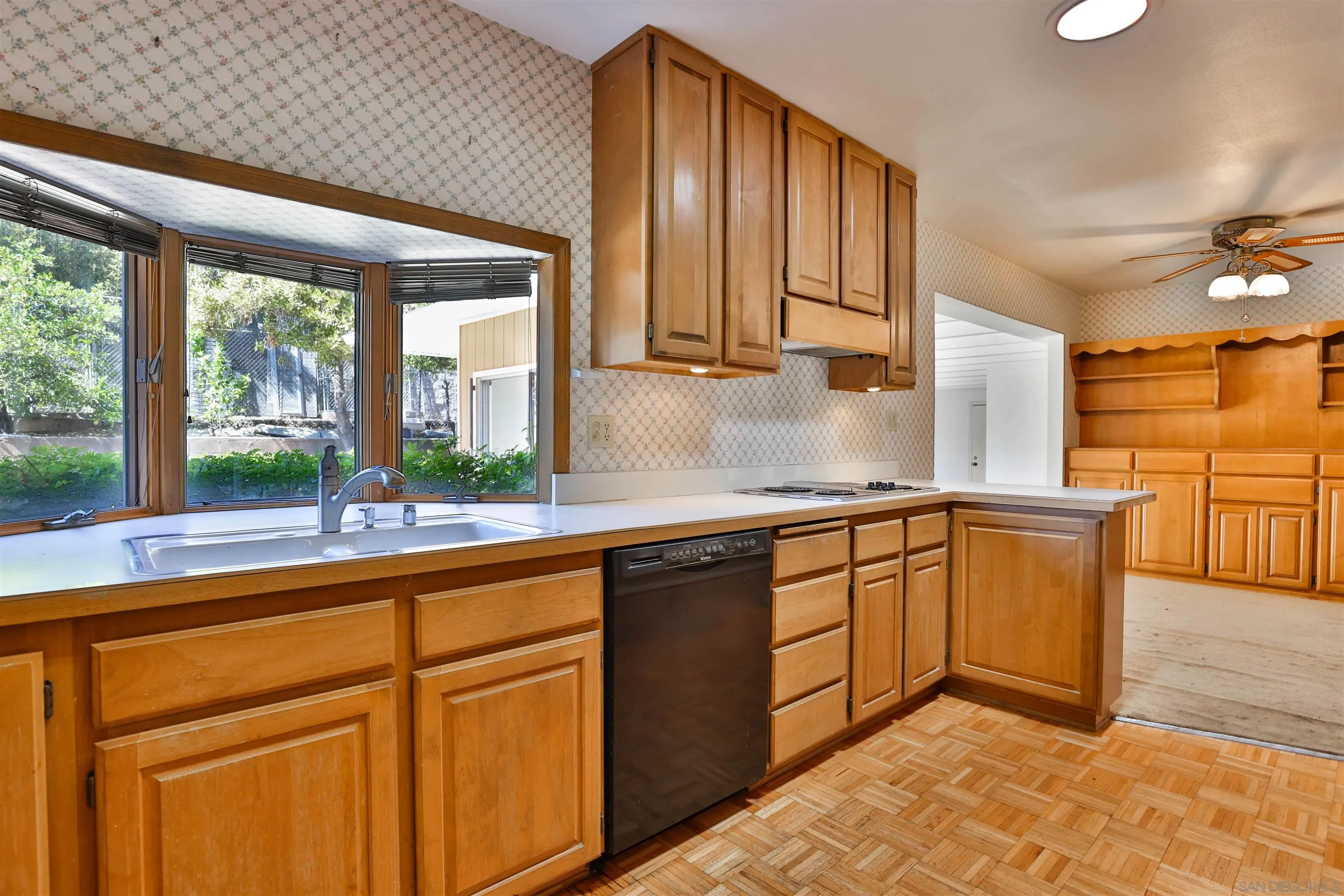 10320 Rancho Road La Mesa, CA 91941 - Photo 16 of 43 a kitchen with granite countertop wooden cabinets a sink and a window
