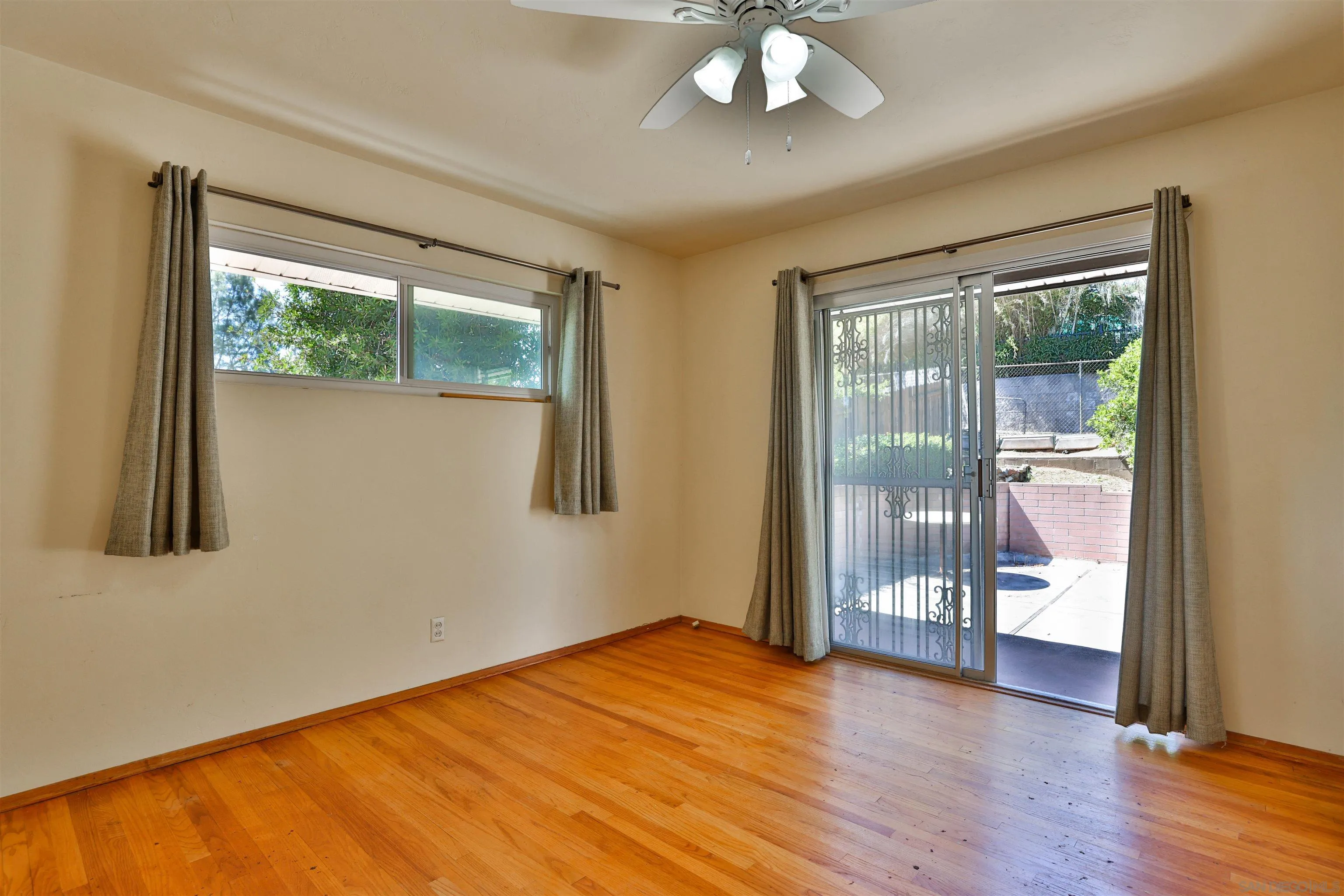 10320 Rancho Road La Mesa, CA 91941 - Photo 27 of 43 a view of an empty room with wooden floor and a window