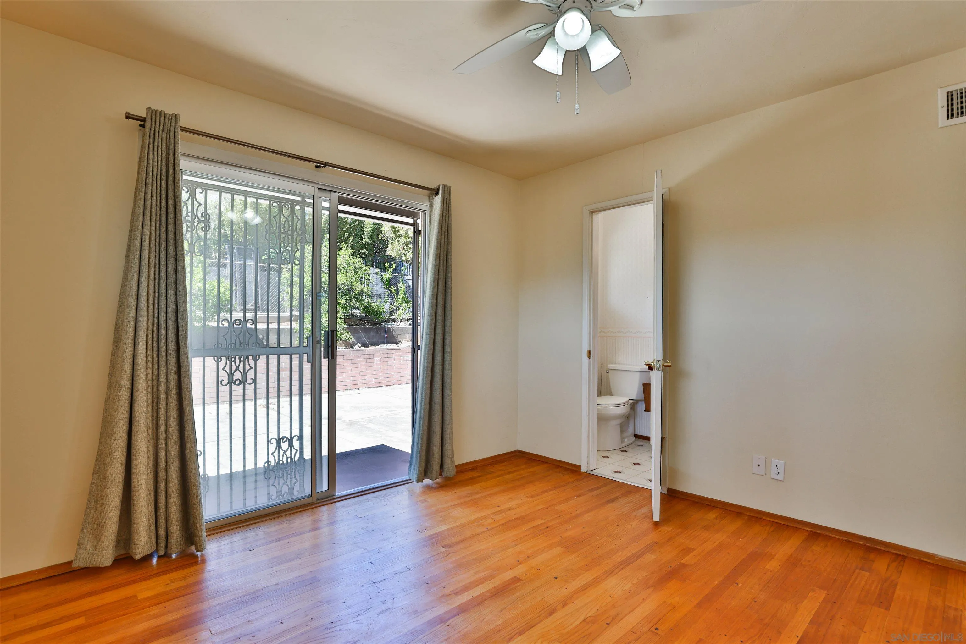 10320 Rancho Road La Mesa, CA 91941 - Photo 28 of 43 an empty room with wooden floor and windows