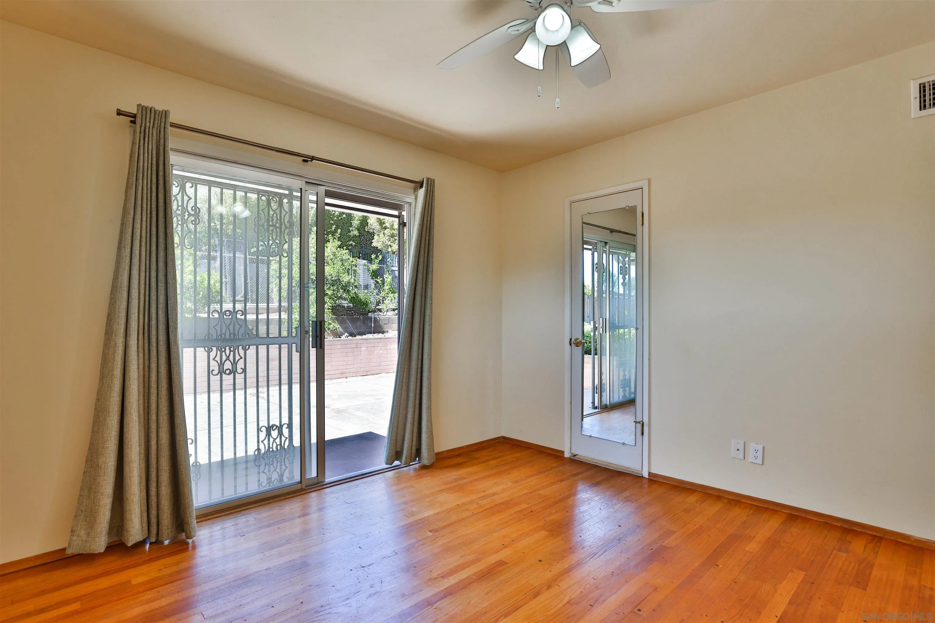 10320 Rancho Road La Mesa, CA 91941 - Photo 29 of 43 a view of an empty room with wooden floor and a window