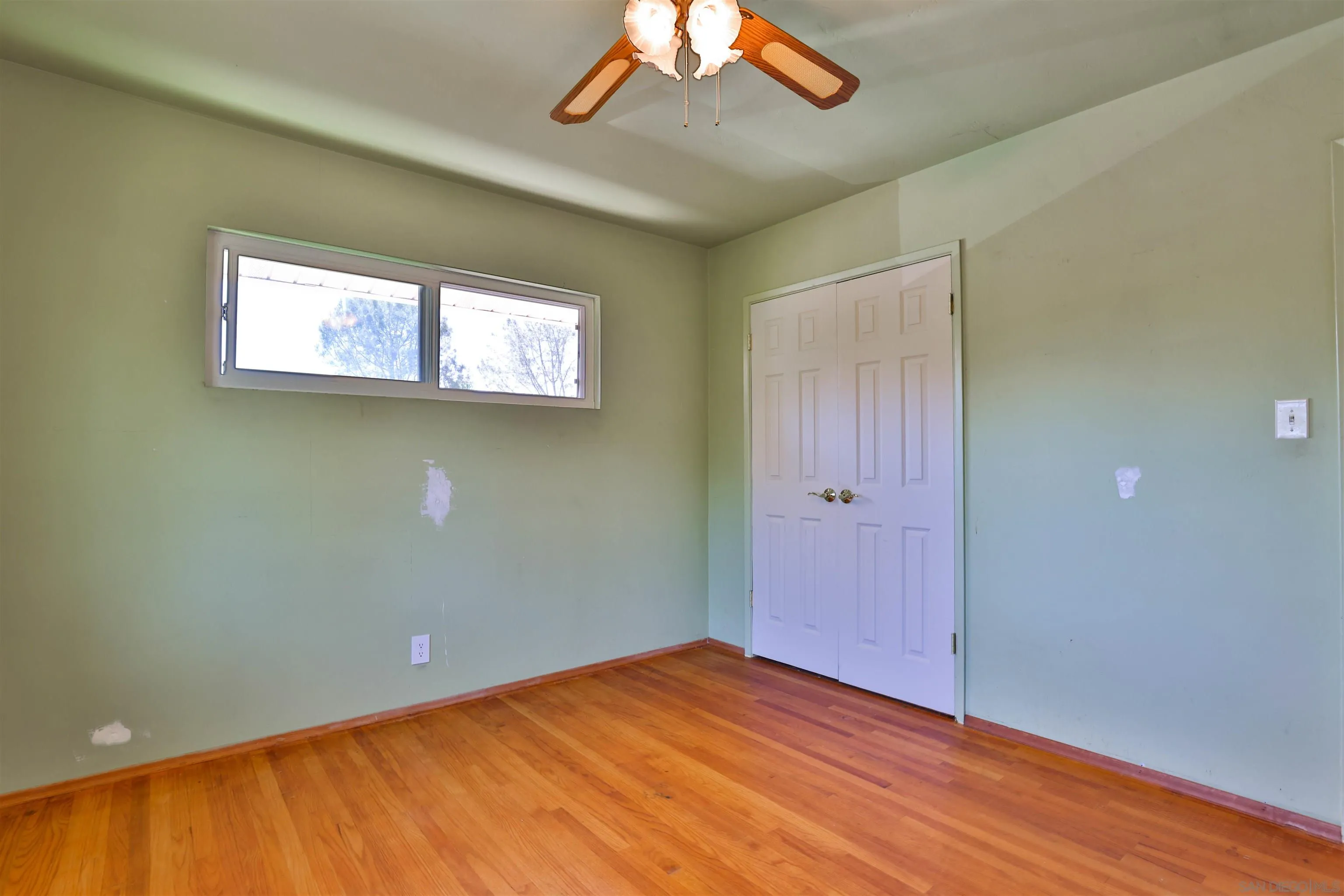 10320 Rancho Road La Mesa, CA 91941 - Photo 33 of 43 a view of an empty room with wooden floor and a window