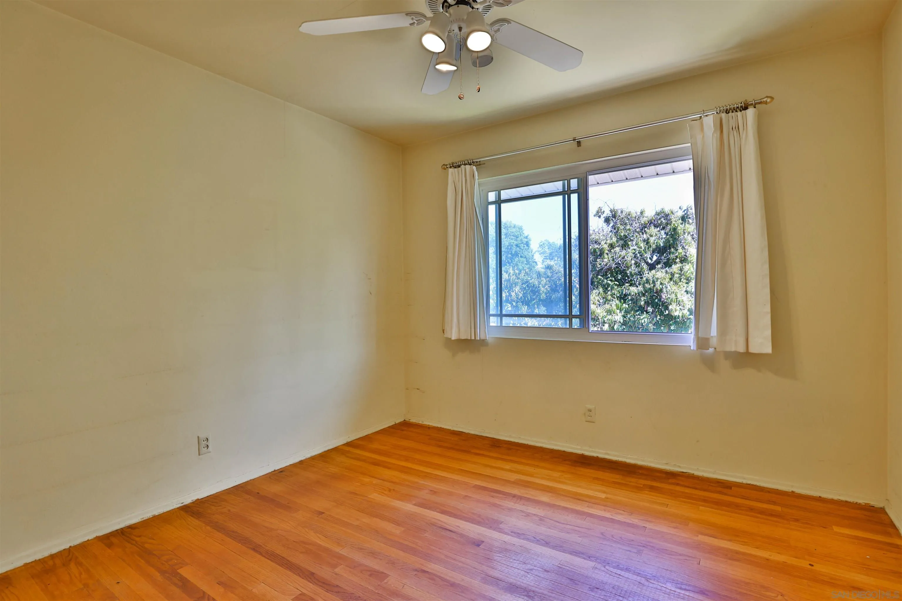 10320 Rancho Road La Mesa, CA 91941 - Photo 34 of 43 a view of an empty room with wooden floor and a window