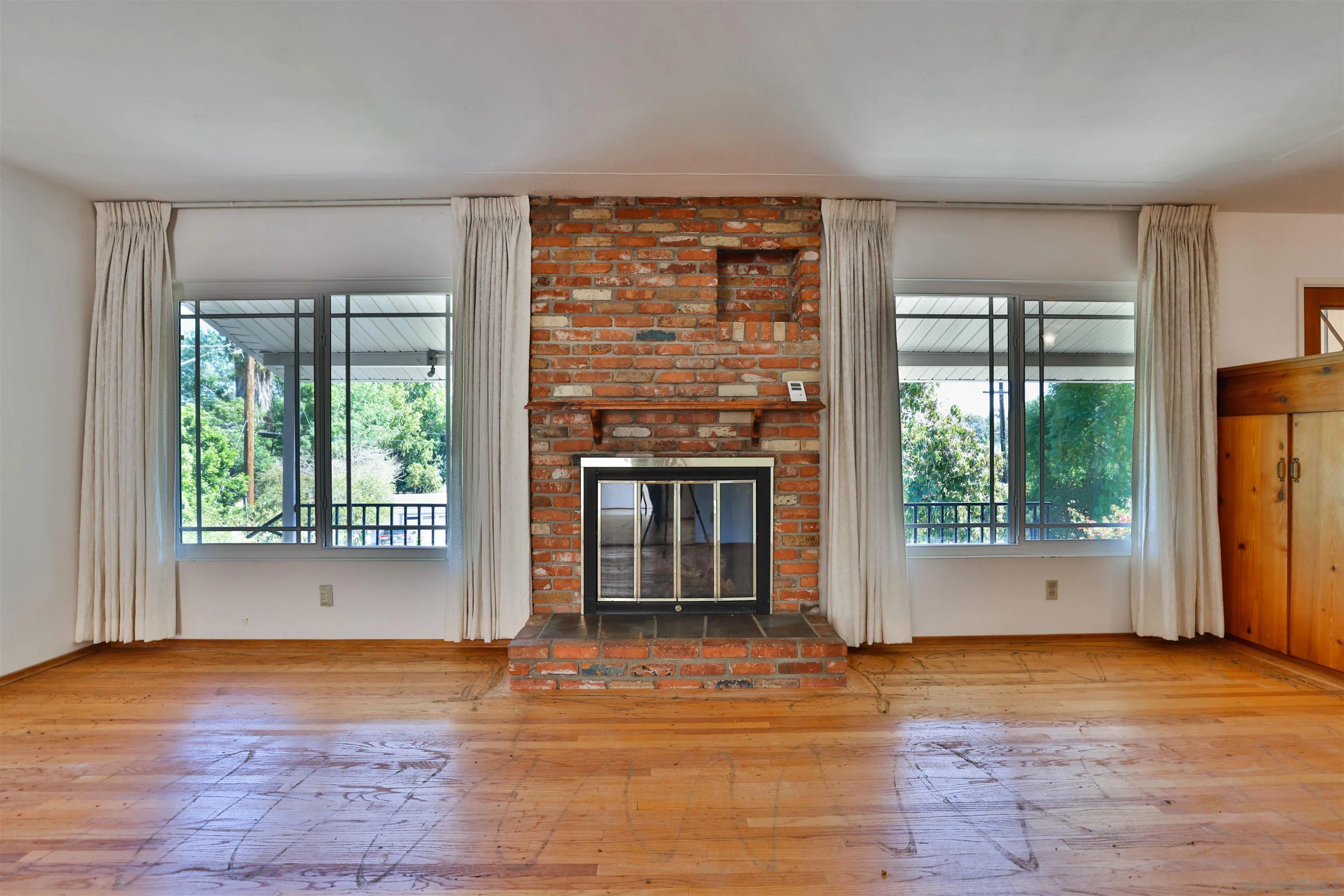 10320 Rancho Road La Mesa, CA 91941 - Photo 8 of 43 a view of empty room with wooden floor and a fireplace