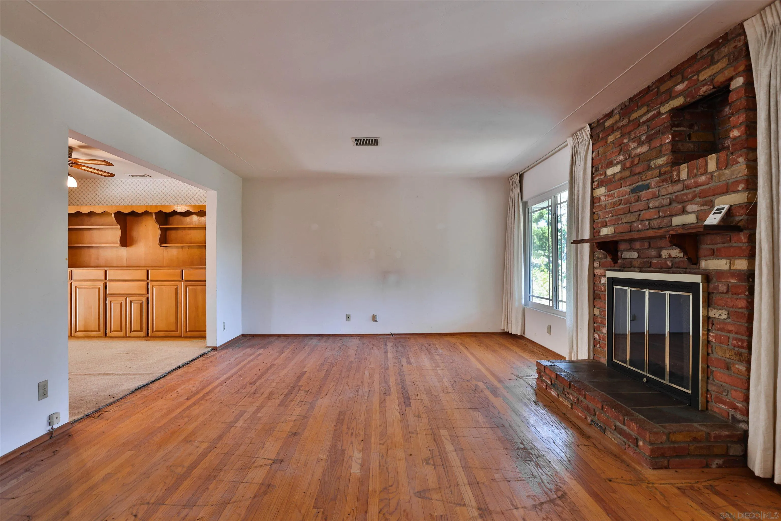 10320 Rancho Road La Mesa, CA 91941 - Photo 10 of 43 a view of empty room with wooden floor and fan