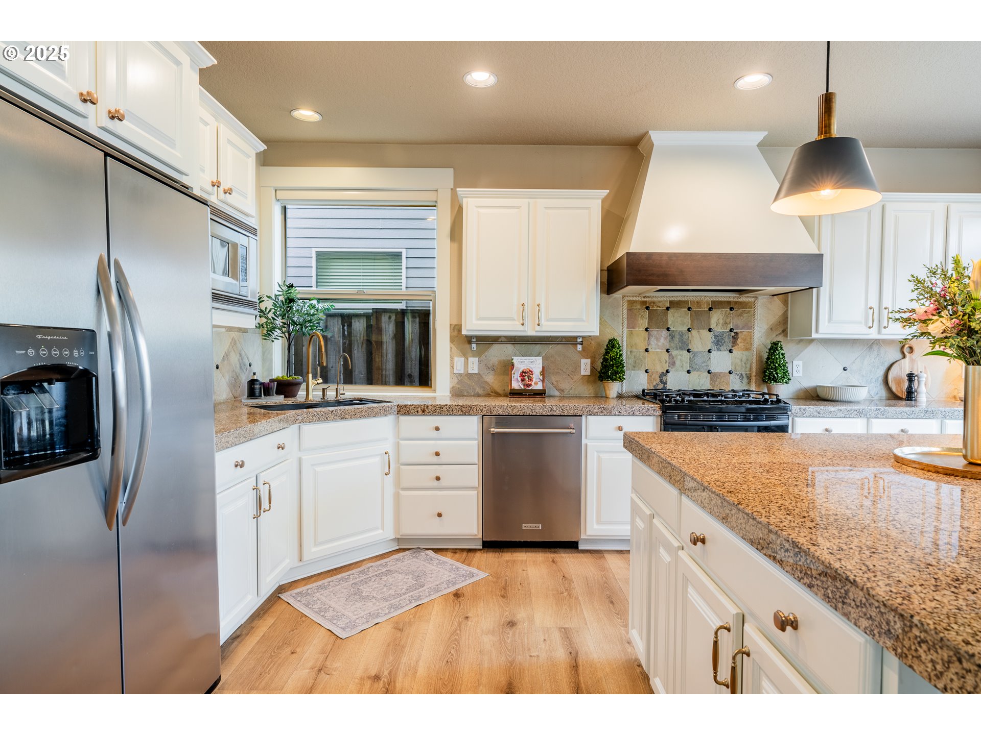 16472 Southwest 133rd Terrace Tigard, OR 97224 - Photo 11 of 48 a kitchen with stainless steel appliances granite countertop a sink a stove and a refrigerator