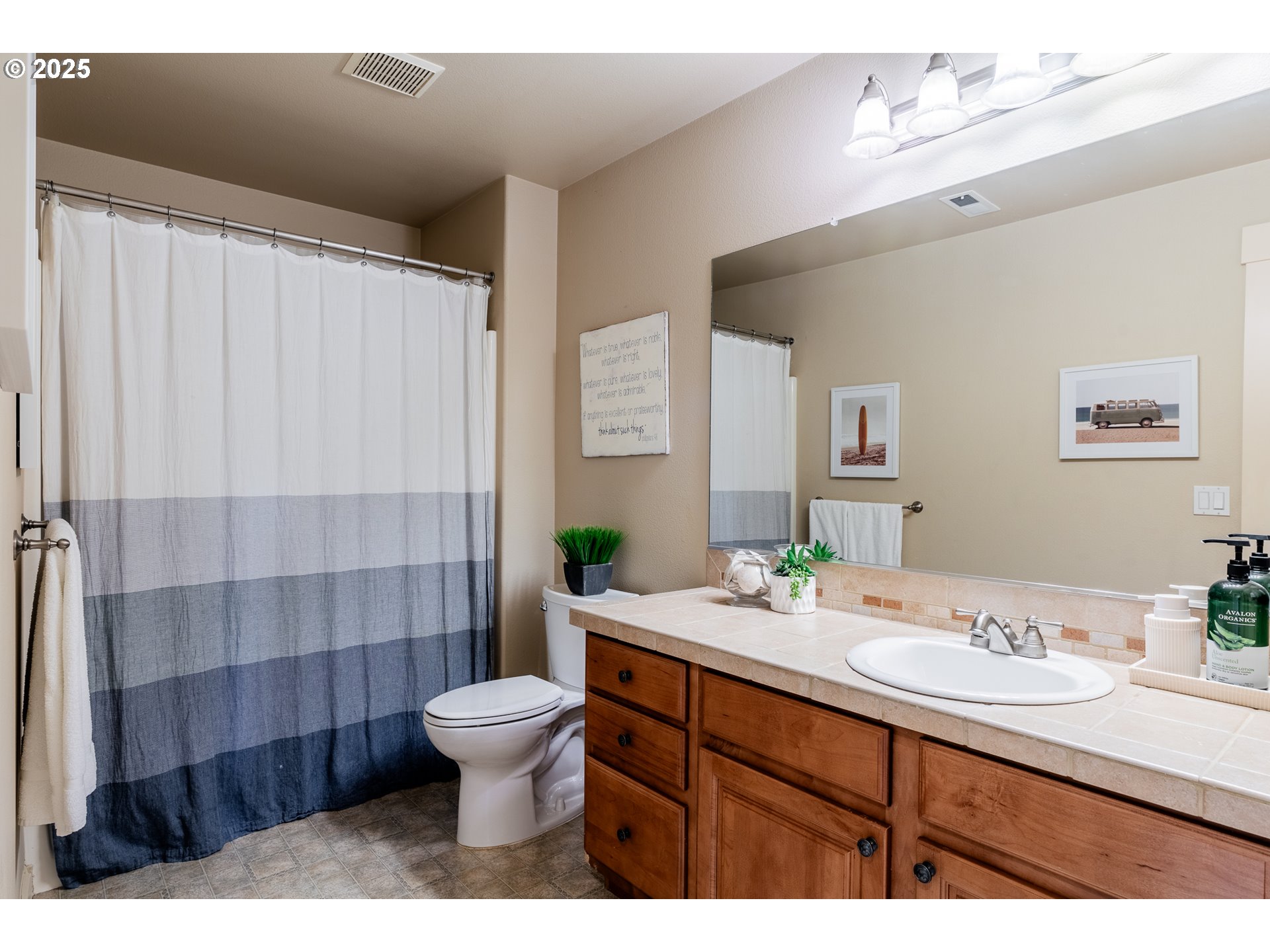 16472 Southwest 133rd Terrace Tigard, OR 97224 - Photo 21 of 48 a bathroom with a double vanity sink toilet and shower