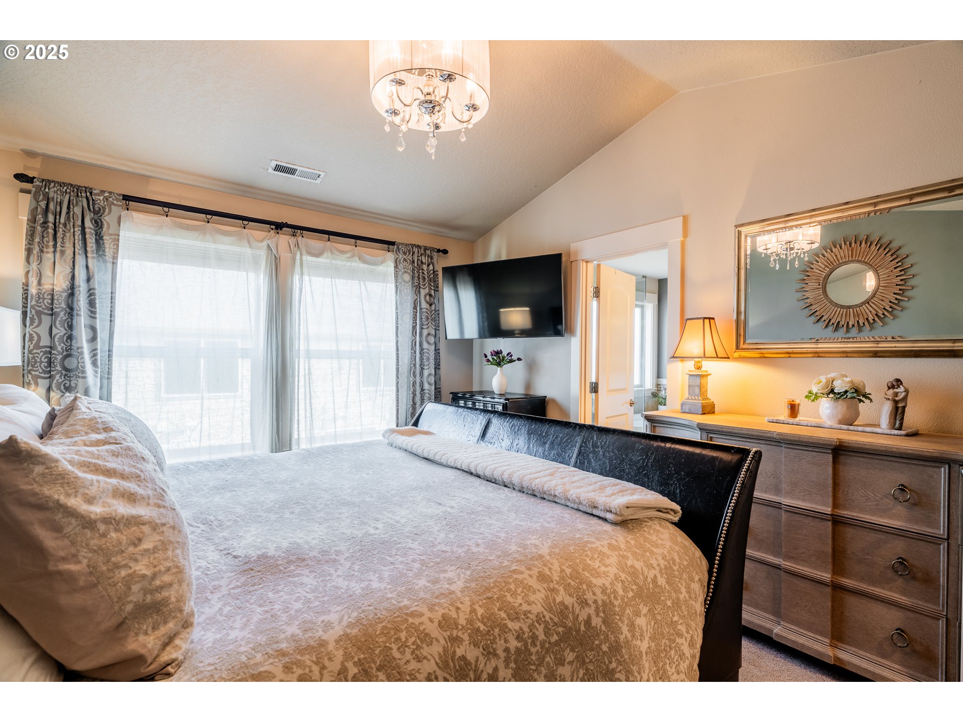 16472 Southwest 133rd Terrace Tigard, OR 97224 - Photo 27 of 48 a bedroom with a bed and a chandelier