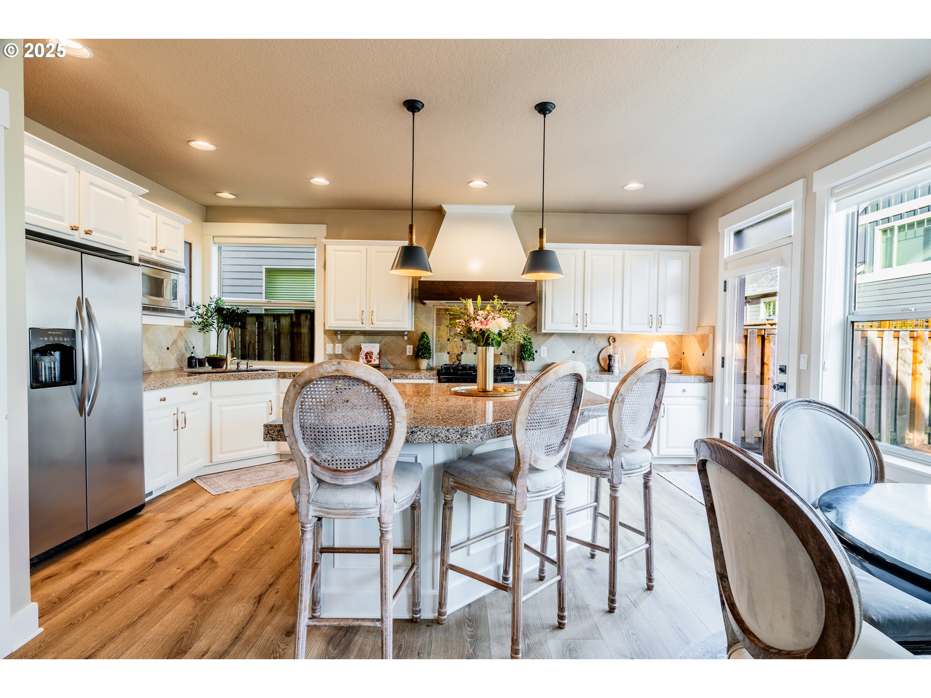 16472 Southwest 133rd Terrace Tigard, OR 97224 - Photo 9 of 48 a kitchen with stainless steel appliances granite countertop a sink refrigerator dining table and chairs