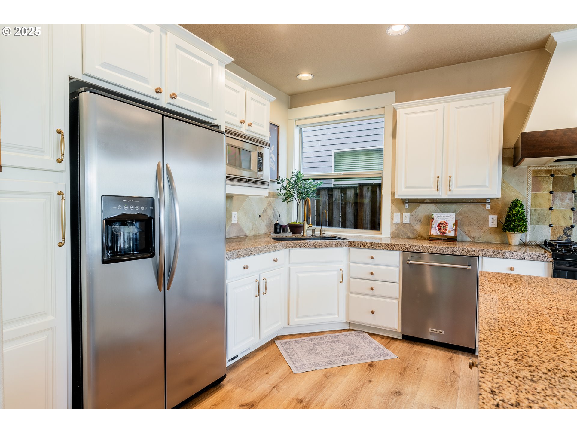 16472 Southwest 133rd Terrace Tigard, OR 97224 - Photo 10 of 48 a kitchen with stainless steel appliances a refrigerator sink and cabinets