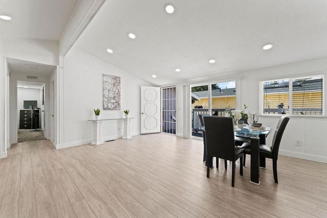 a view of a livingroom with furniture and a flat screen tv