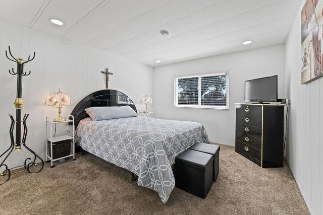 a bedroom with a bed and large mirror