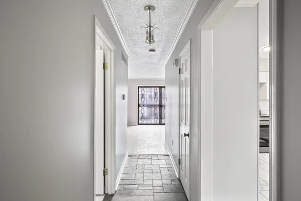a very nice looking hallway with a large window and chandelier