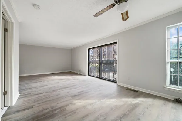 an empty room with windows and entrance